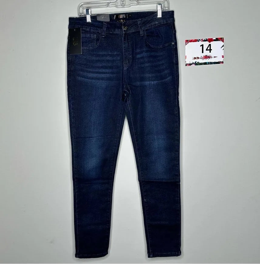 Dark indigo mid-rise skinny jeans with subtle whiskering and classic five-pocket design hanging on clear hanger